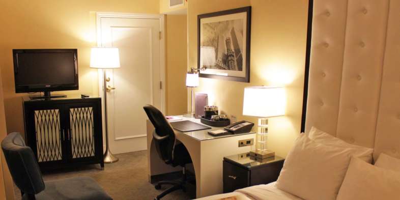 Mesa de trabalho, cama e TV do quarto do hotel Warwick Allerton em Chicago