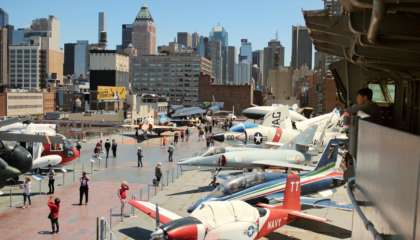 O convés superior do Intrepid está repleto de aviões e helicópteros de diversos períodos do século XX