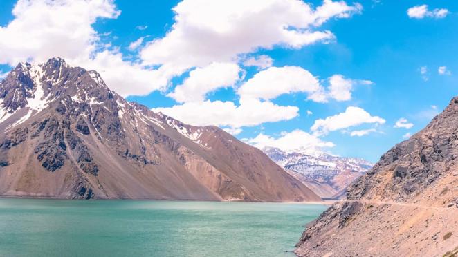 Viagem de carro: Embalse el Yeso O Embalse el Yeso com céu azul, águas verdes e a Cordilheira dos Andes